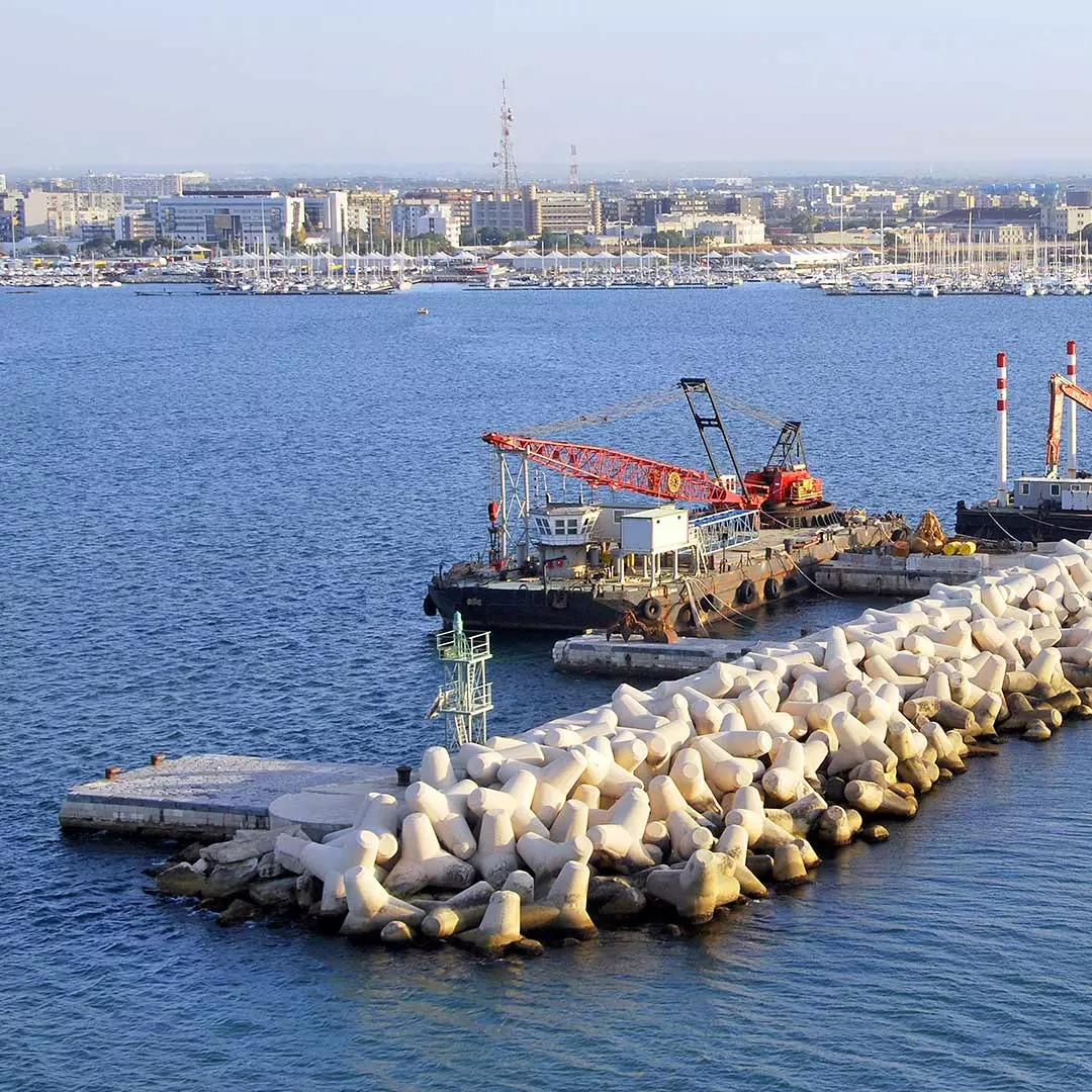 Barges behind harbor break wall 
